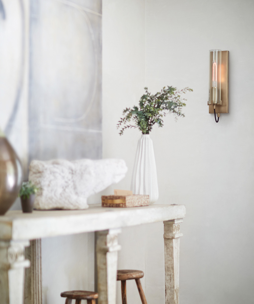 Gold and glass sconce in living area