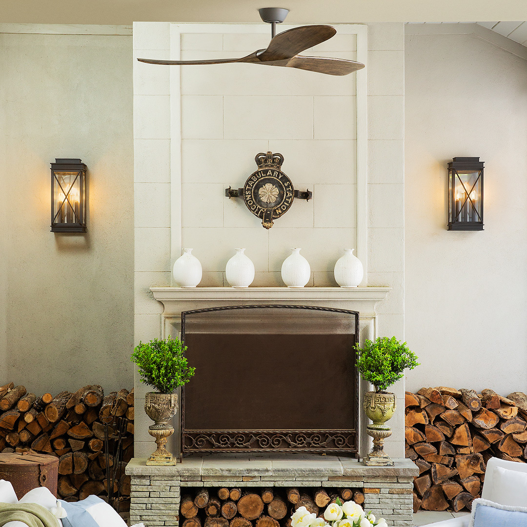 Rustic metal sconces by fireplace