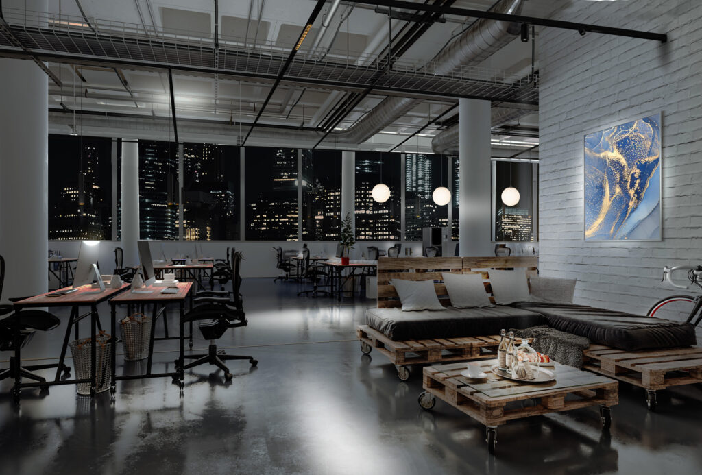 a modern office area at night with large windows and bulb hanging lights above a couch area