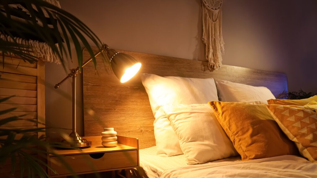 lamp by a bed on a night stand