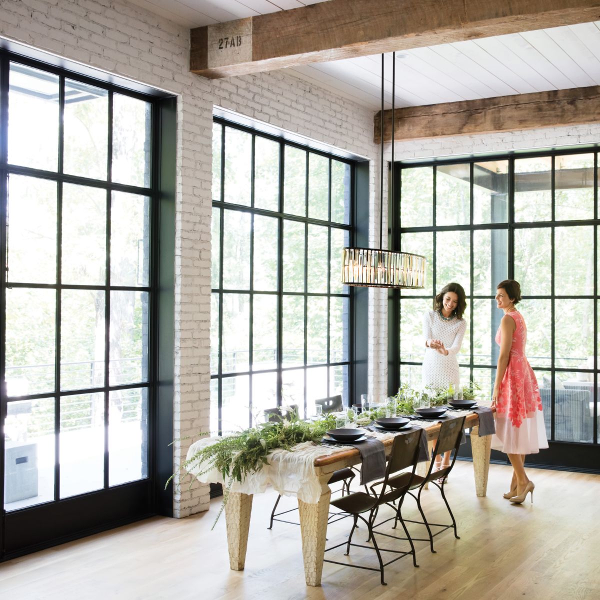 Image of two women in a room with a nice light fixture